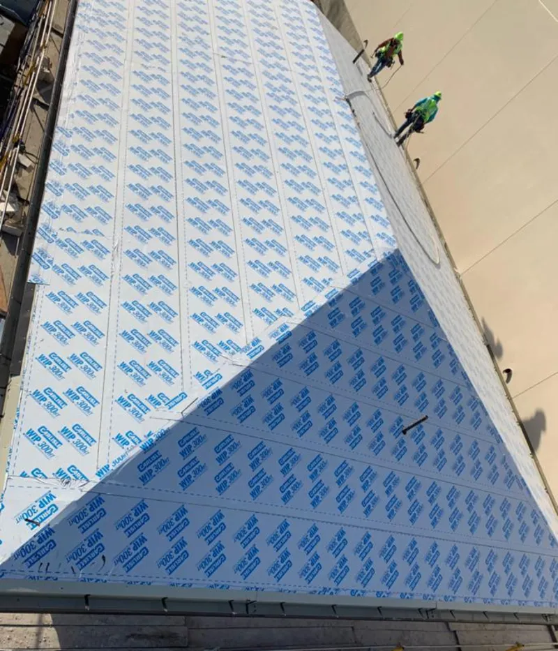 Professional roofers installing underlayment on a metal roof in St. Martin